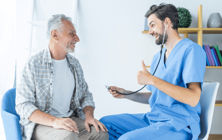 young doctor gesturing thumb up elderly patient